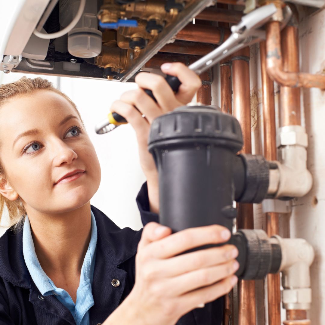 woman fixing boiler